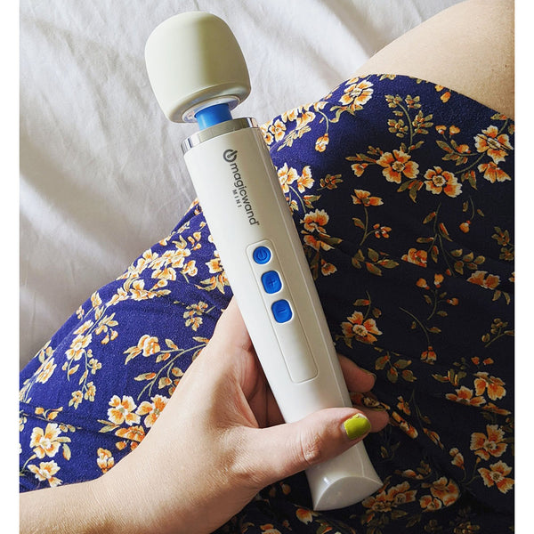 Product shot of the Hitachi Magic Wand Mini personal massager being held in a womans hand.